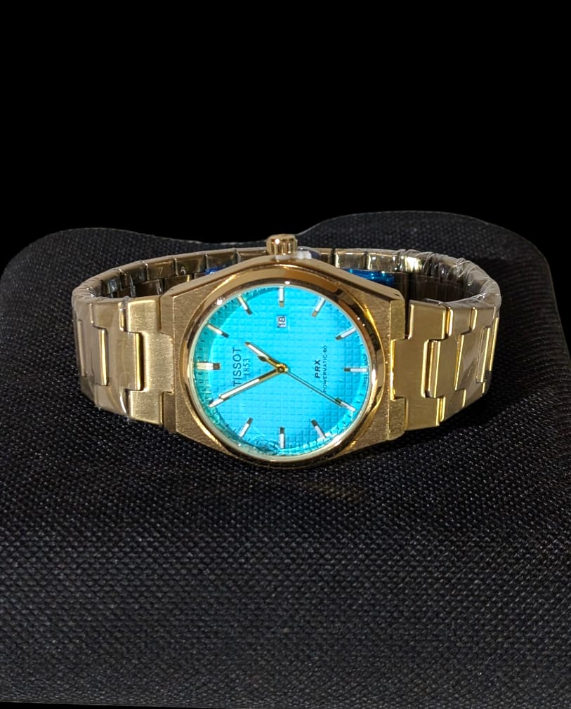 Reloj de acero TISSOT para hombres, modelo PRX Powermatic 80 automático con dial texturizado y brazalete integrado.